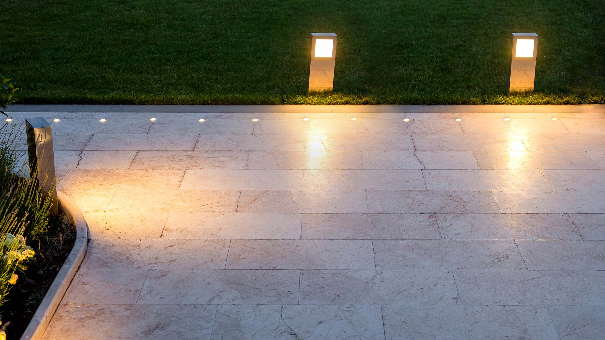 A well-lit pathway with modern ground and bollard lights enhancing safety.
