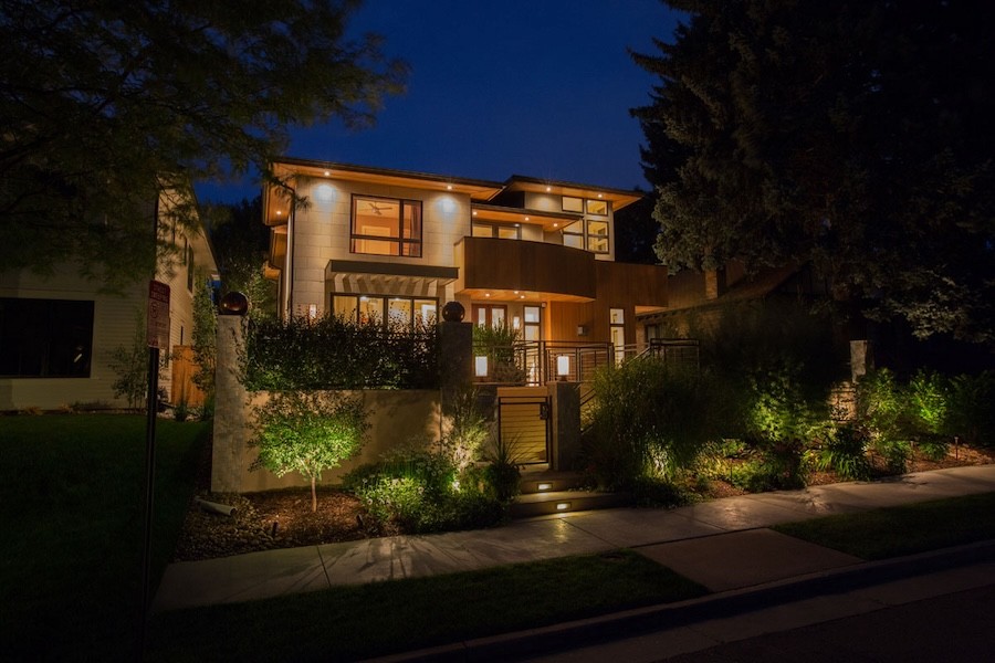 Landscape lighting illuminates a 2-story luxury home.