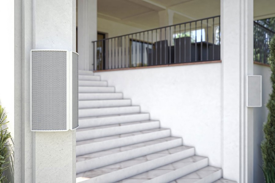 Two Razor speakers mounted on support posts in front of stairs.