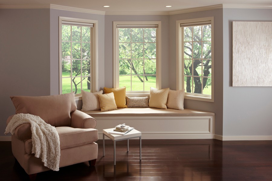 A reading niche with three windows featuring Lutron motorized shades.