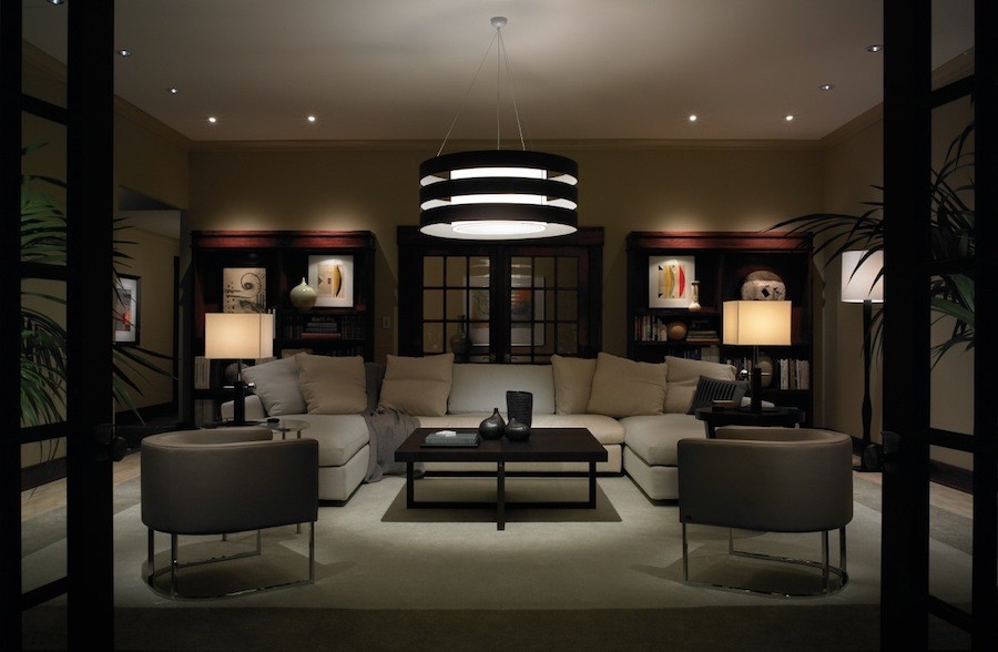 A living room is dimly lit by lighting control in the evening to save energy.